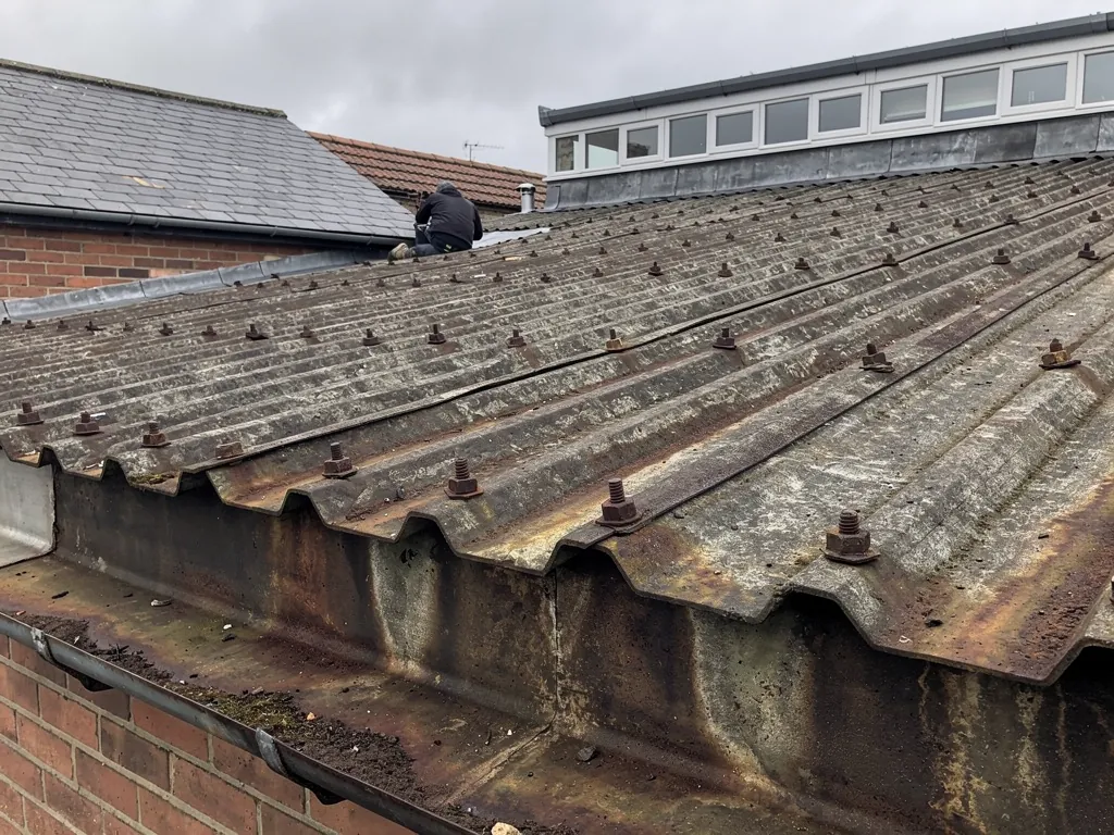 Corroded fasteners and rust on old profiled metal roof sheets