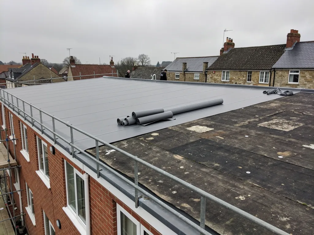 Long flat roof on a 1960s brick building being re-covered