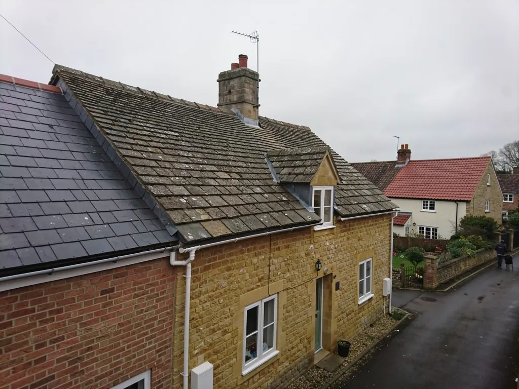 Cotswold stone cottage with a steep stone slate roof