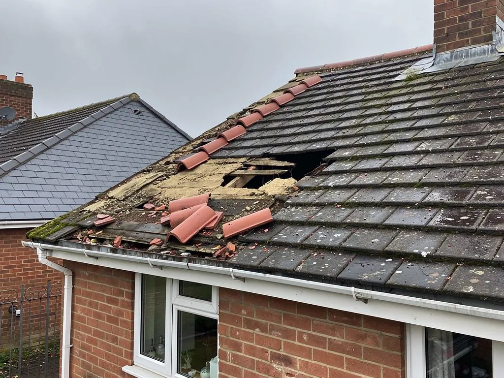 Ridge tiles blown off a concrete tile roof after a gale