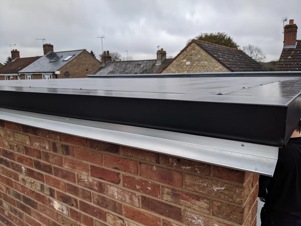 New EPDM membrane and drip trim on a garage roof edge