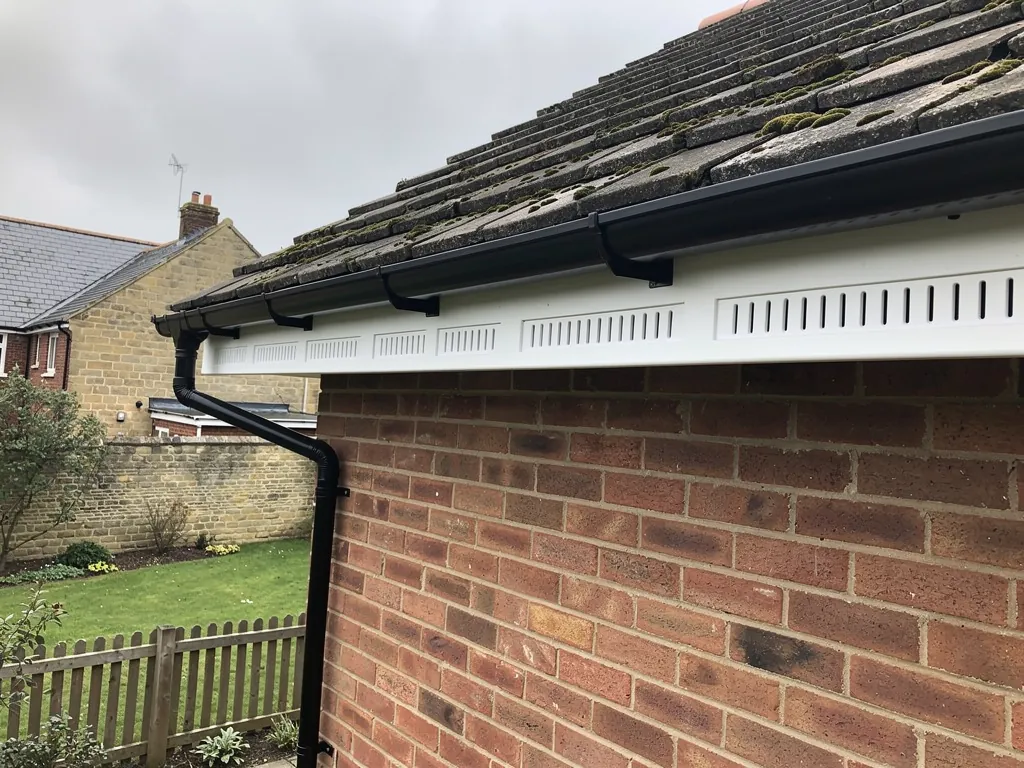 New white uPVC fascia, soffit and black gutter on brick eaves