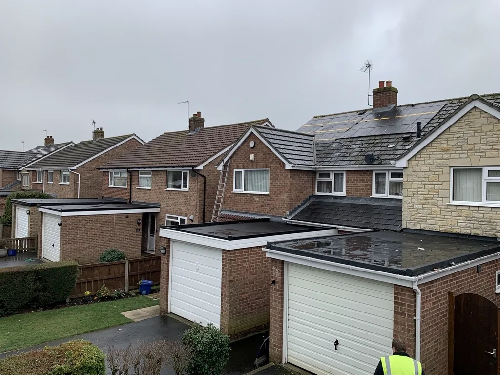 Brick semis with concrete tile roofs and flat-roofed garages