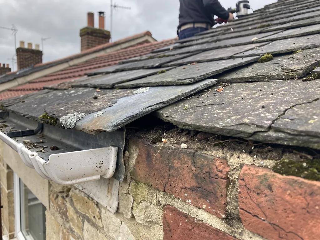 Split old lead flashing pulling away from a brick abutment