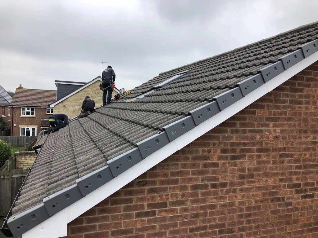 Grey dry verge units along the gable of a concrete tile roof
