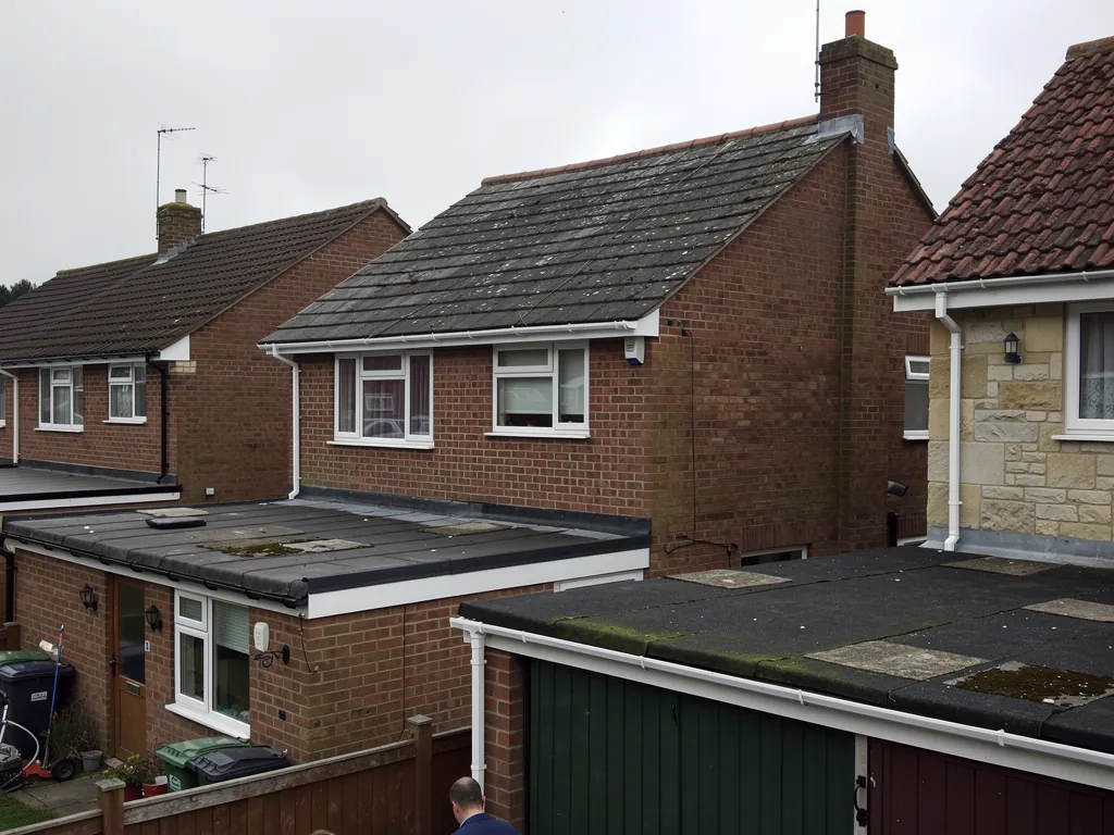 Gabled cottage roofs with chimney stacks