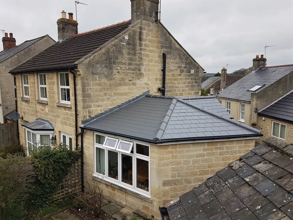 Stone house with a new grey tiled conservatory roof