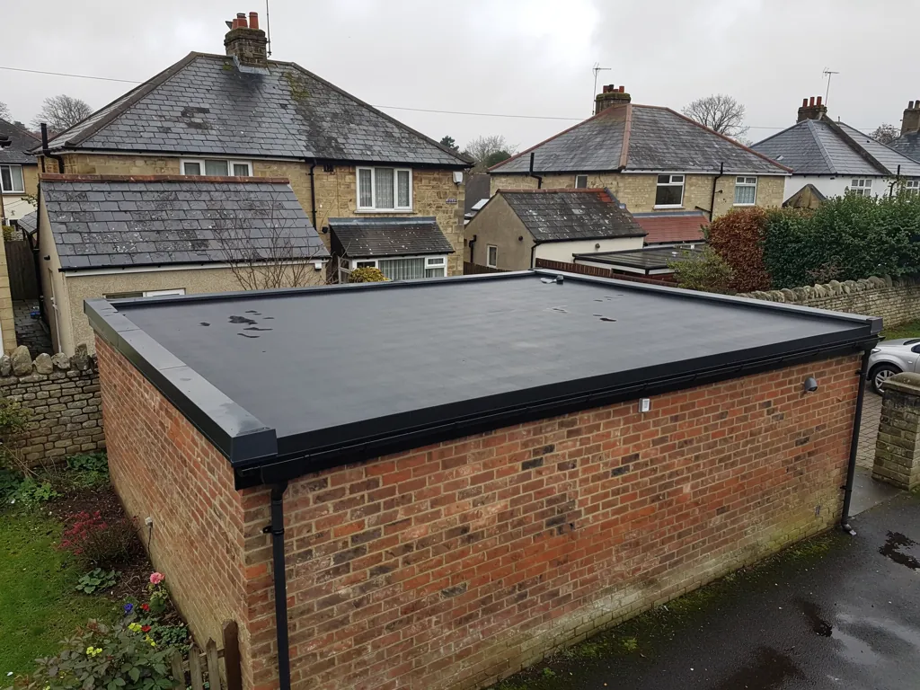 Brick garage finished with a black rubber flat roof