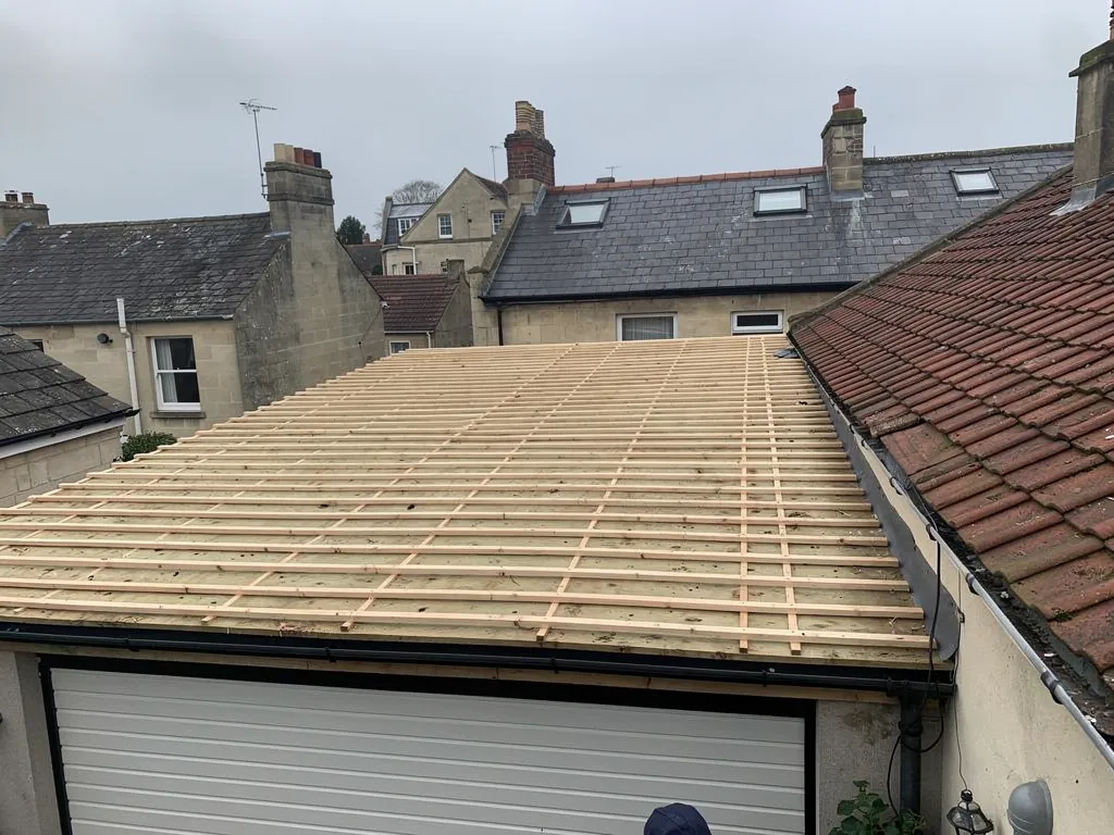 Garage roof stripped to new timber battens above the door