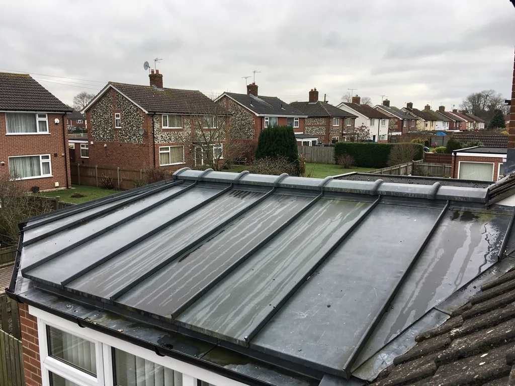 Rolled lead roof covering over a bay above white windows