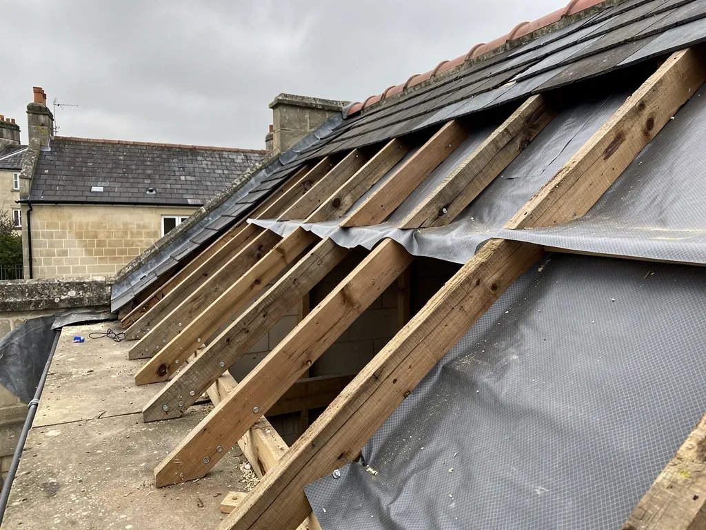 Roof opened to rafters and membrane during foam removal